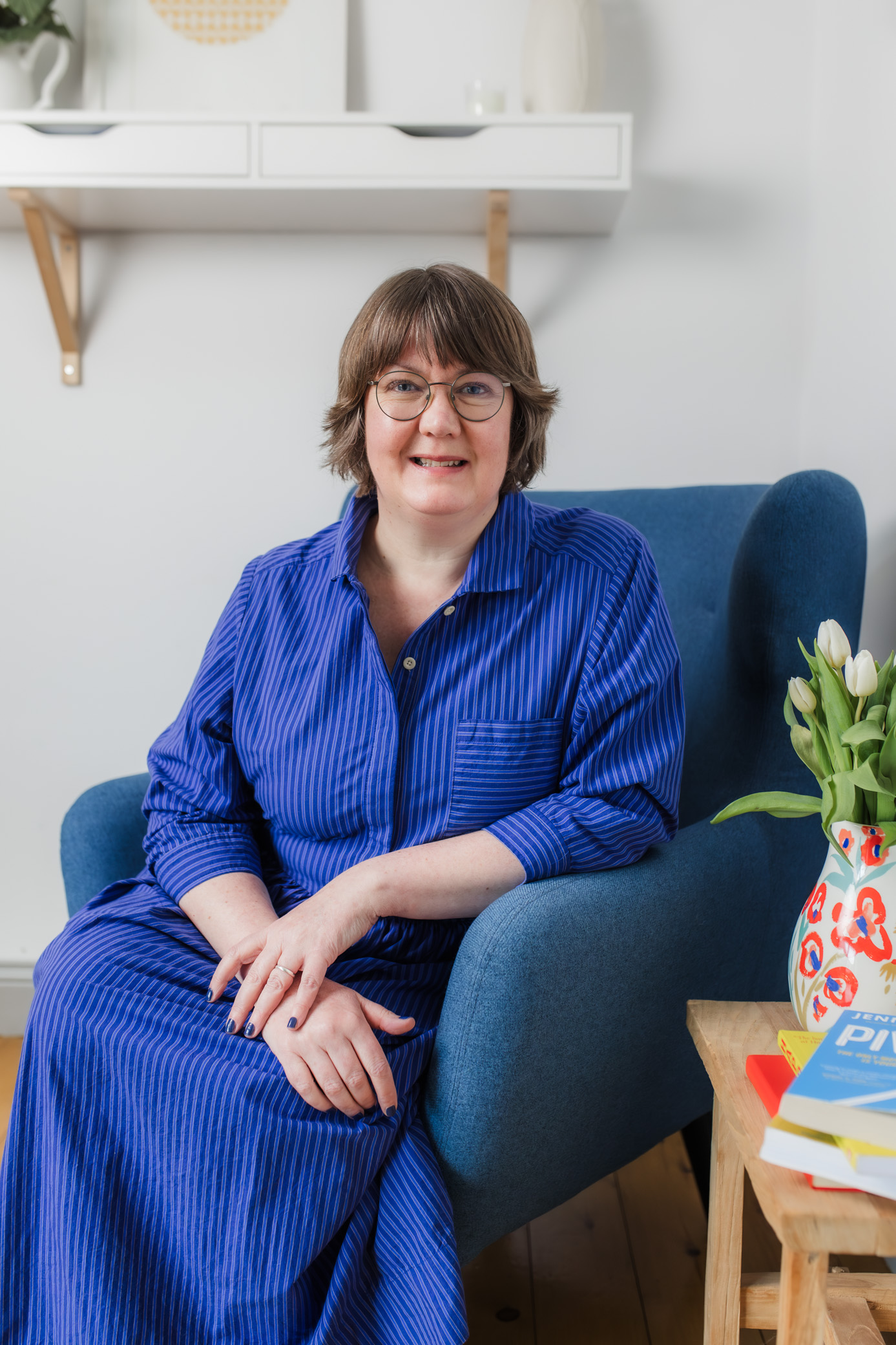 woman in blue dress smiling