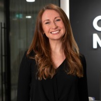 Rebecca Cook with long red hair smiling